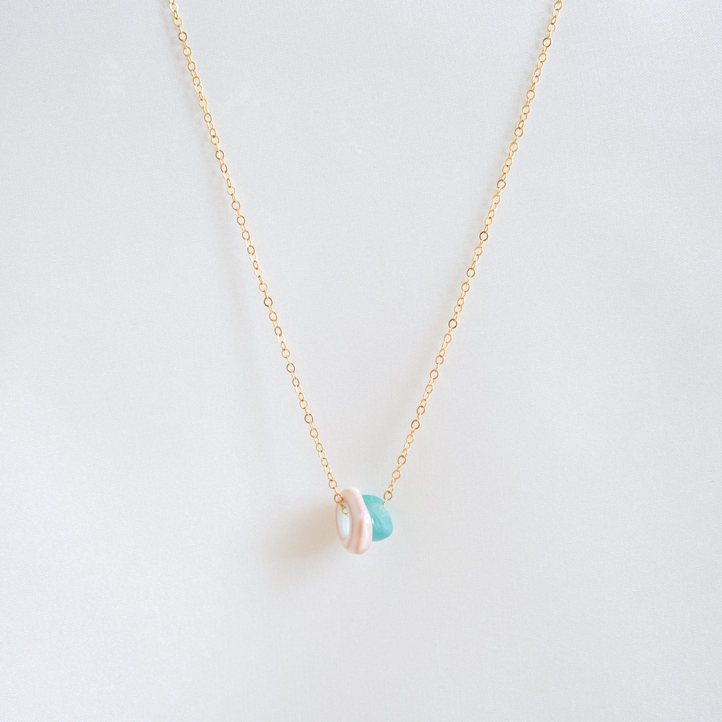 Necklace with sell and blue seaglass charms on gold chain
