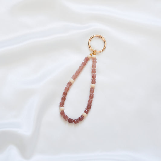 Beaded rose beaded keychain with gold clasp on a white background