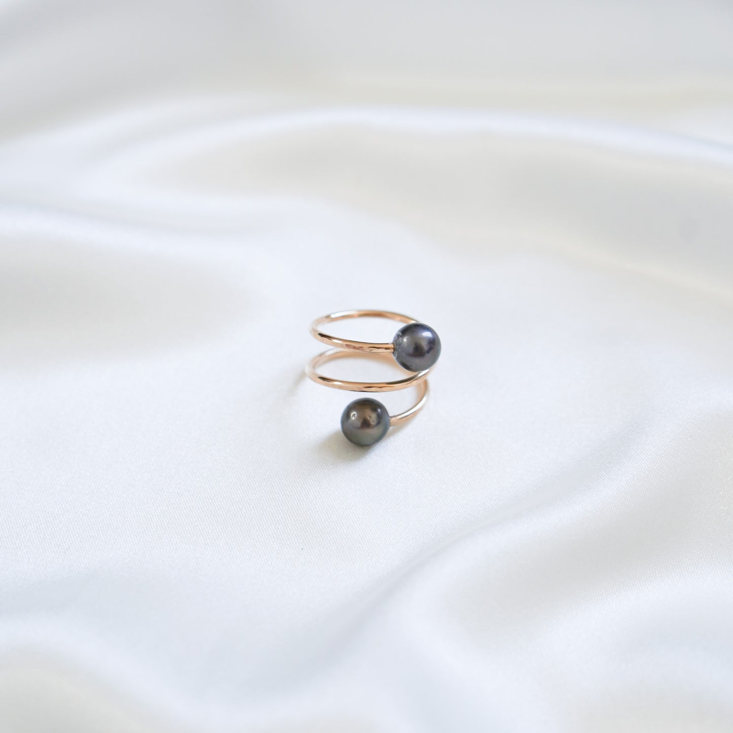Gold ring with tahitian pearls on a white background
