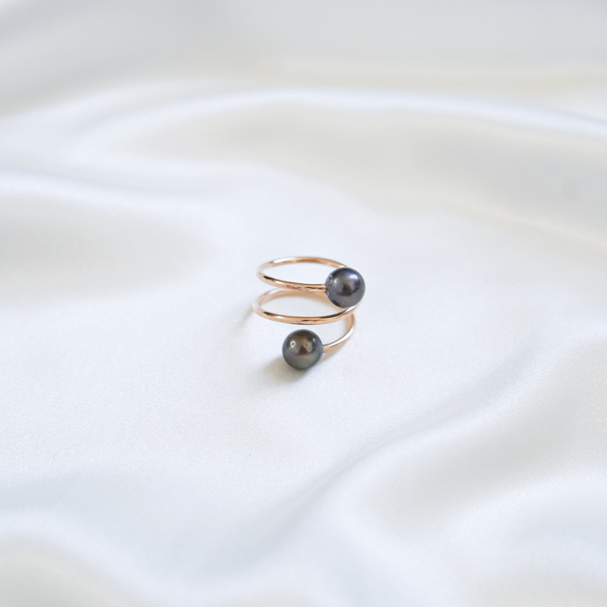 Gold ring with tahitian pearls on a white background