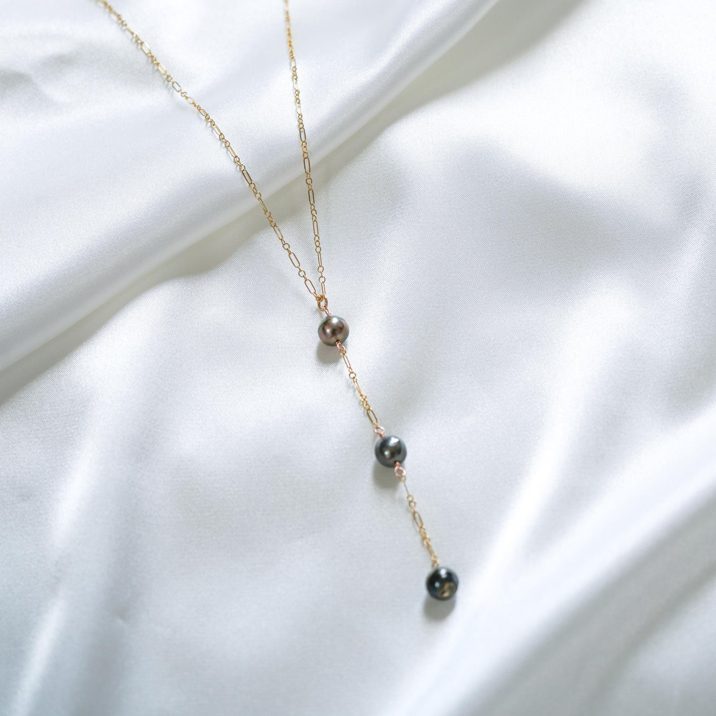 Gold necklace with three hanging pearl pendants 