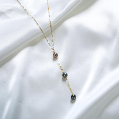 Gold necklace with three hanging pearl pendants 