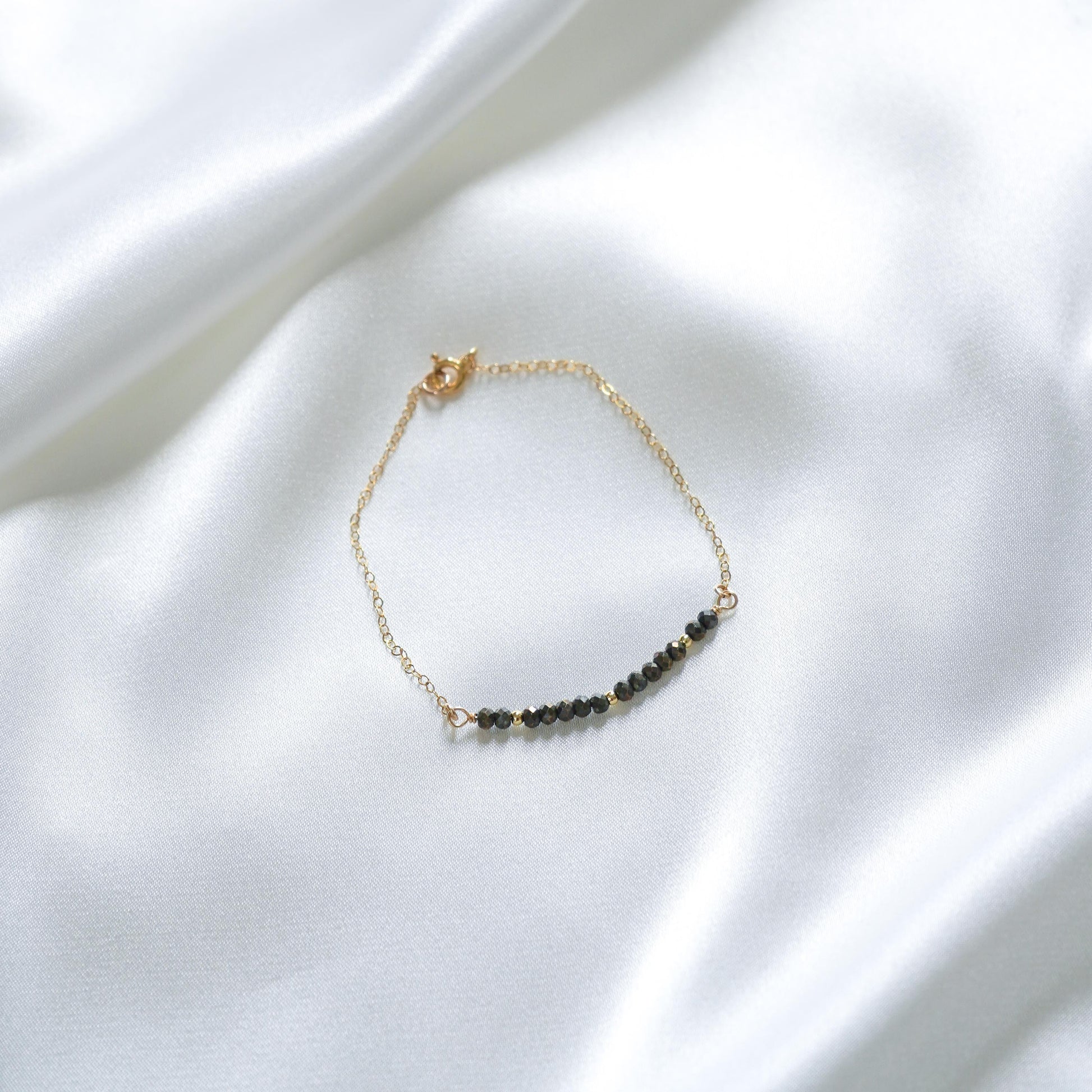 gold chain bracelet with black beads