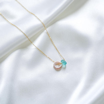 Gold necklace with puka shell and blue sea glass