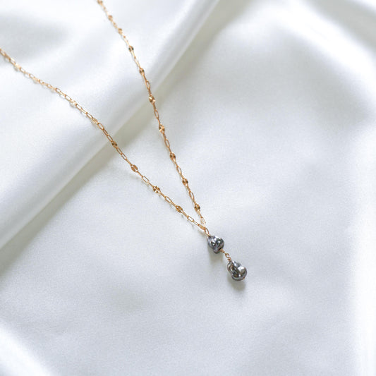 Gold necklace with two dangling pearls