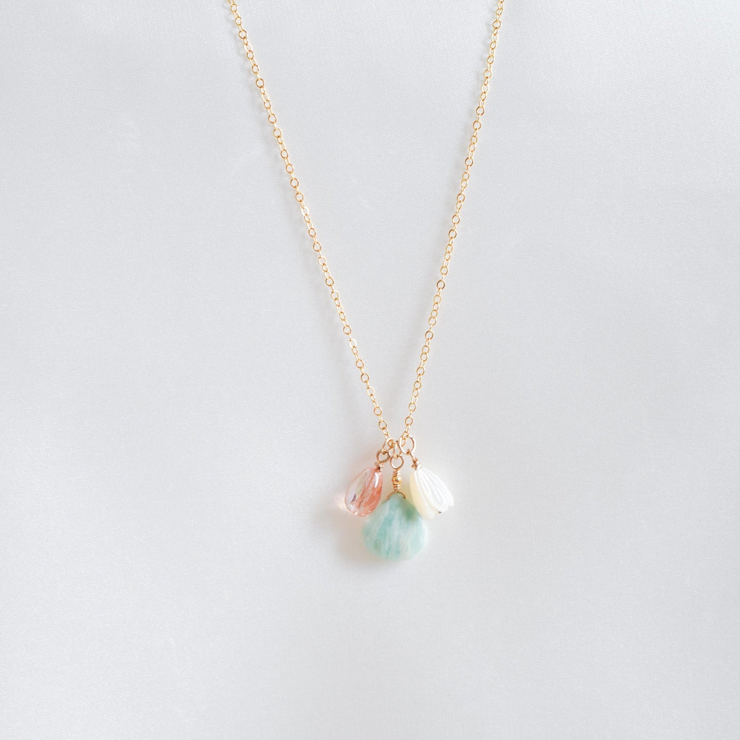 Necklace with pink, green, white charm on gold chain