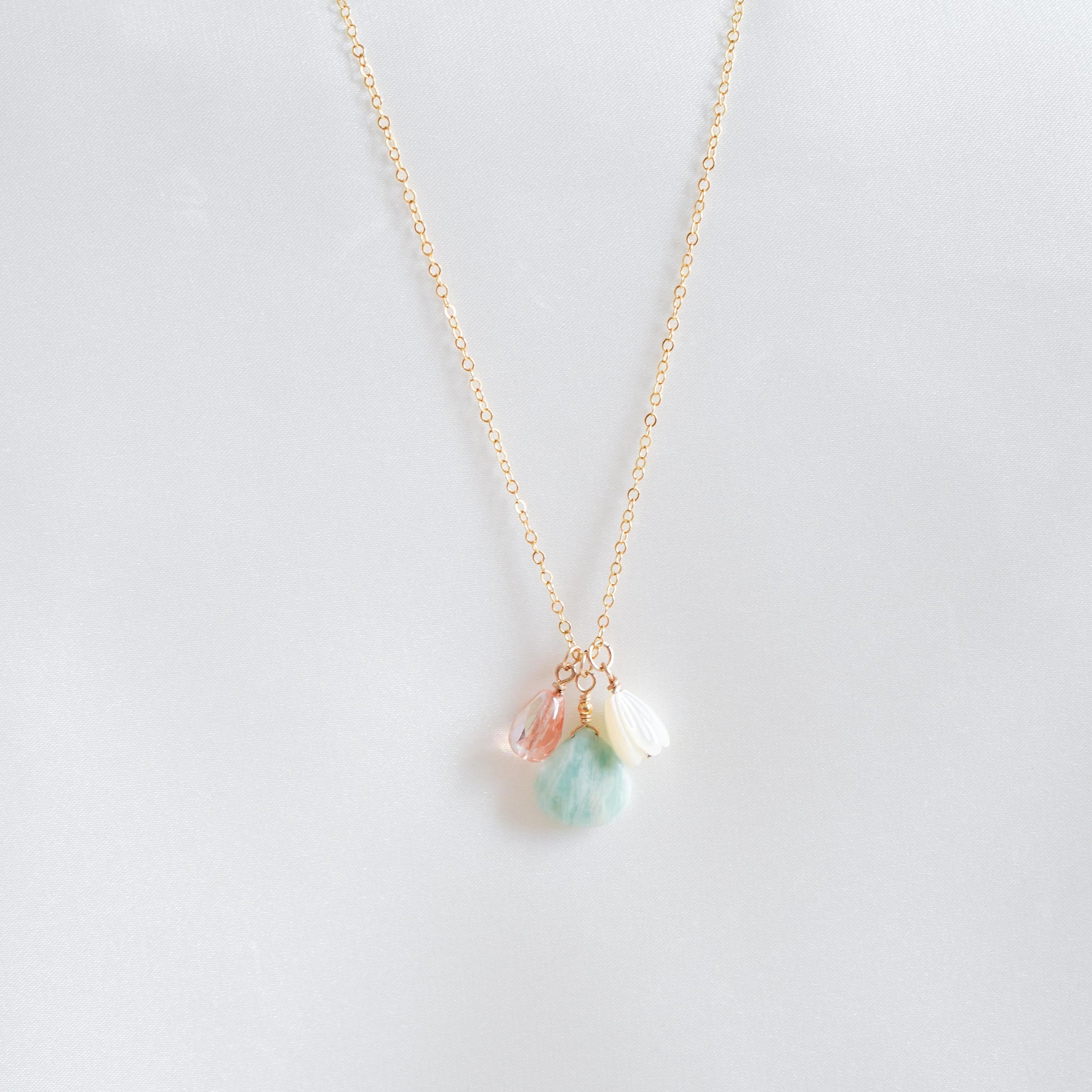Necklace with pink, green, white charm on gold chain