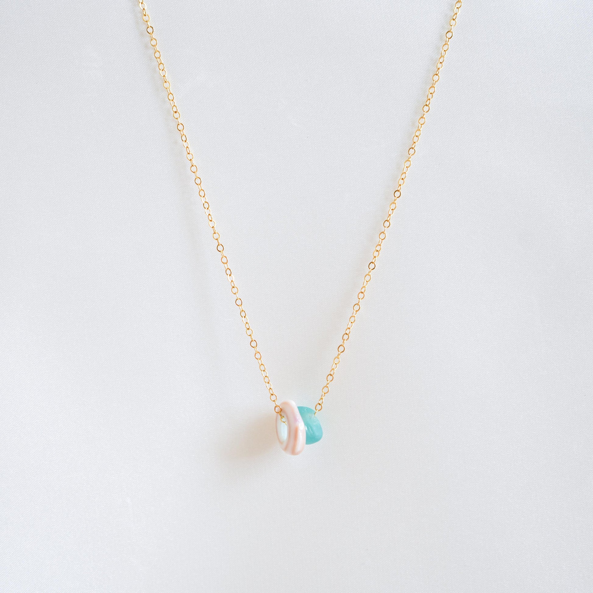 Necklace with sell and blue seaglass charms on gold chain