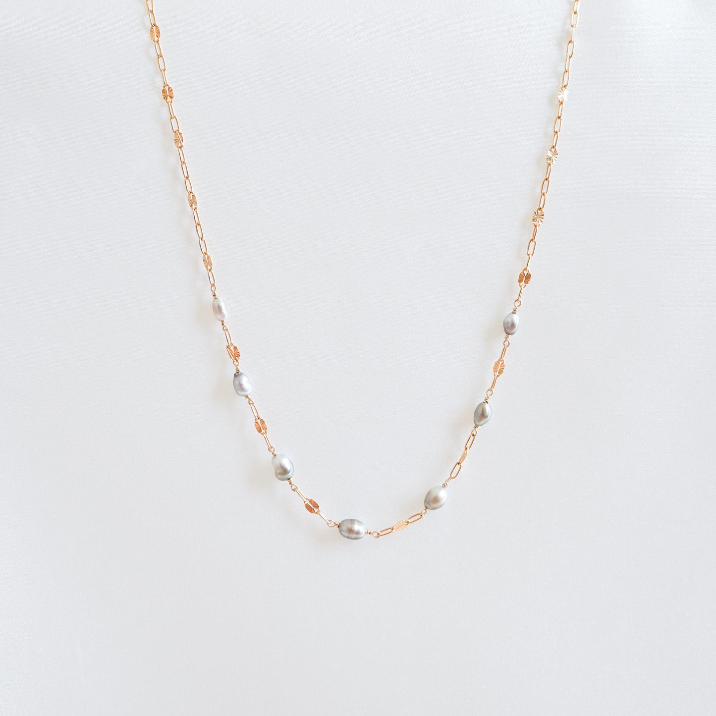 Necklace with seven small keshi pearls on gold chain