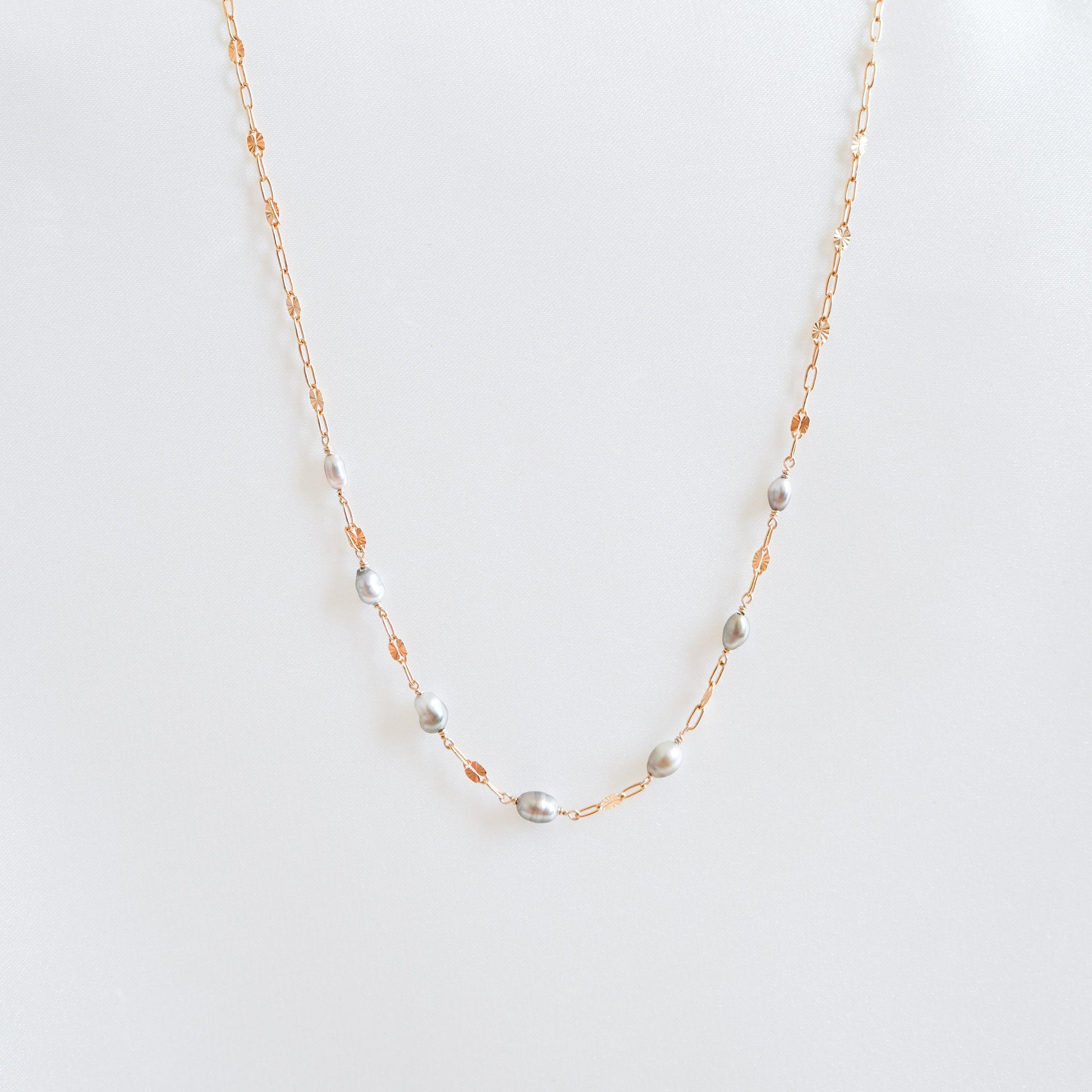 Necklace with seven small keshi pearls on gold chain
