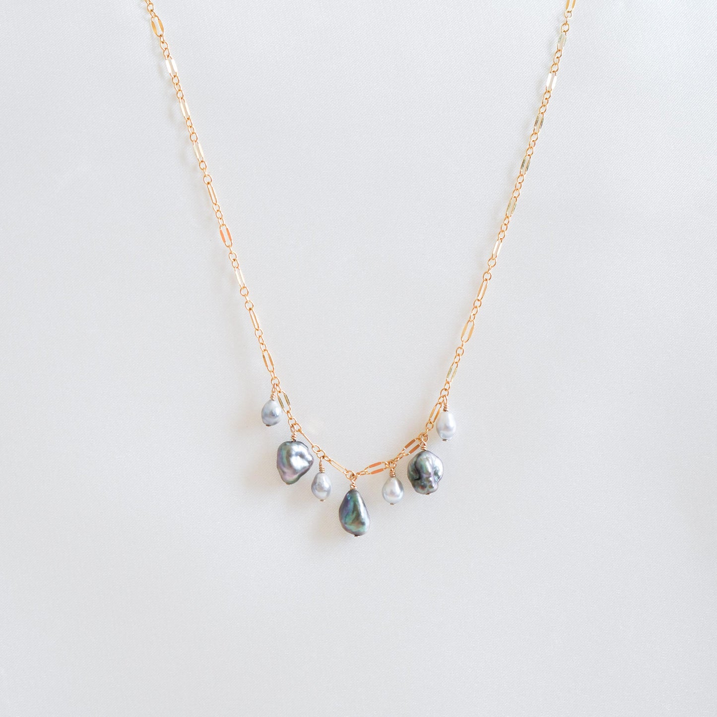 Necklace with three keshi pearls and three smaller pearls alternating on a gold chain