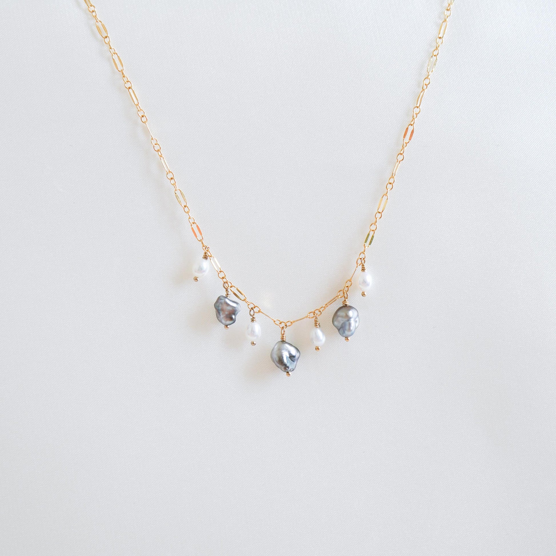 Necklace with three keshi pearls and three smaller pearls alternating on a gold chain