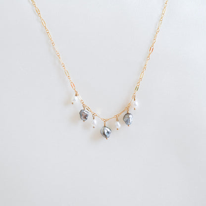 Necklace with three keshi pearls and three smaller pearls alternating on a gold chain