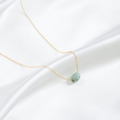 Necklace with a green jade on a white background