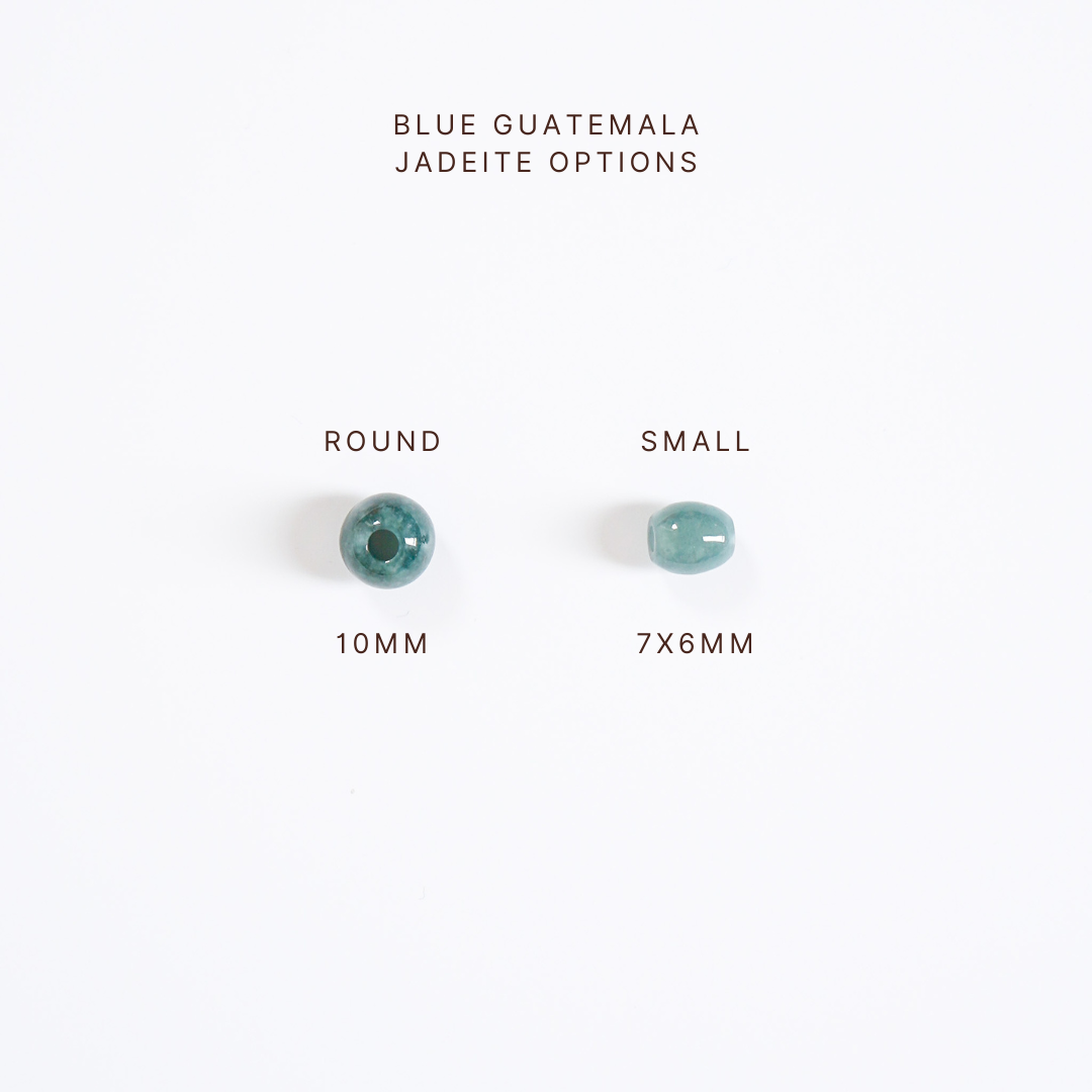 Two blue jadeite beads with size labels on a white background