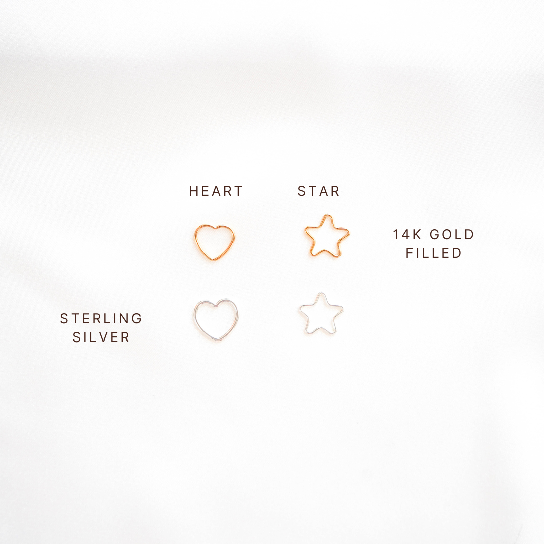 Comparison of gold and silver heart and star charms