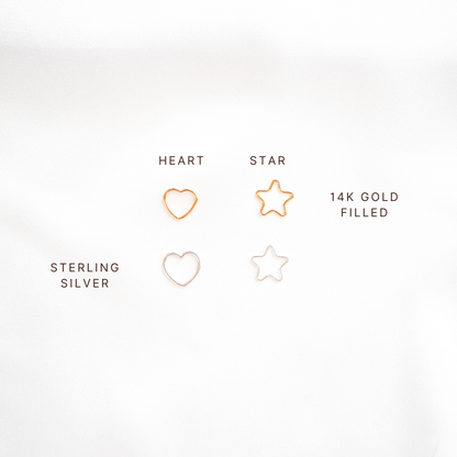 Comparison of gold and silver heart and star charms